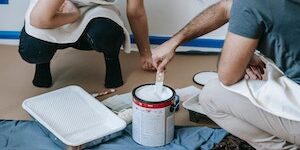 Image of homeowners prepping to paint on Stacie Coder Realtor blog